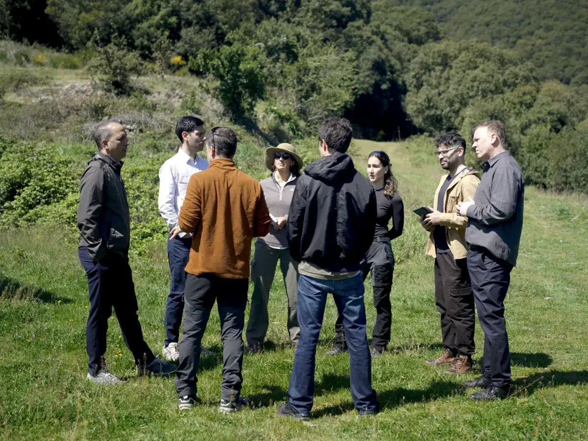 EMFF working group talking in a mountain meadow.